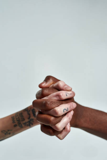 istock Multiracial people putting their fingers together in lock 1307871830