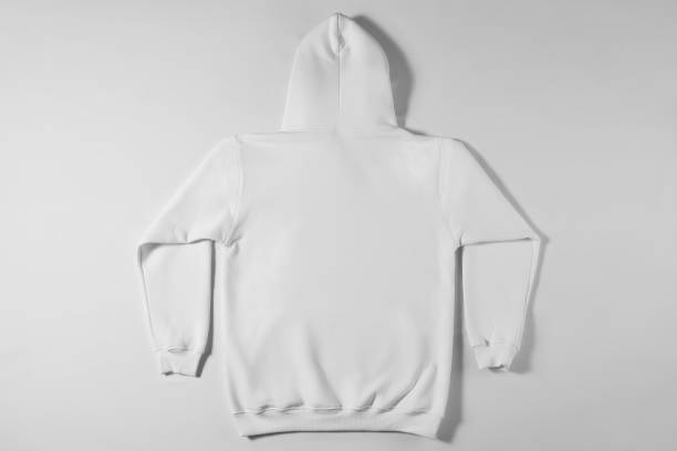 istock White hoodie lying on a light background 1307872528