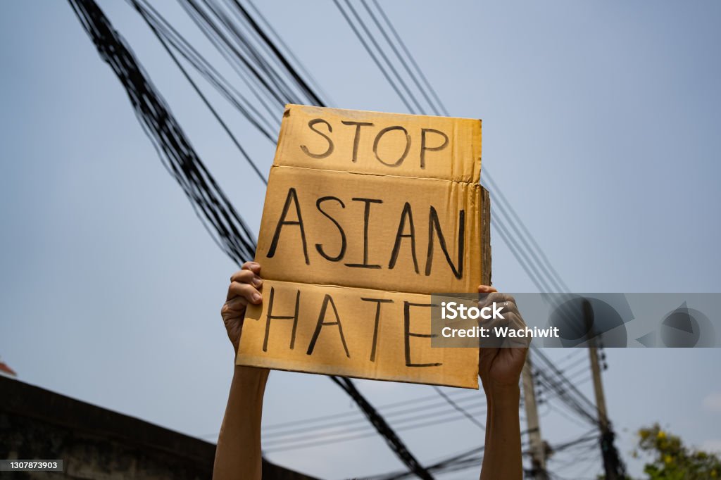 A man holding Stop Asian Hate sign Stop Asian Hate Stock Photo