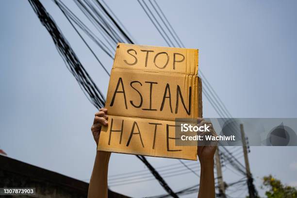 A Man Holding Stop Asian Hate Sign Stock Photo - Download Image Now - Stop Asian Hate, Anti-Asian Racism, Asian and Indian Ethnicities