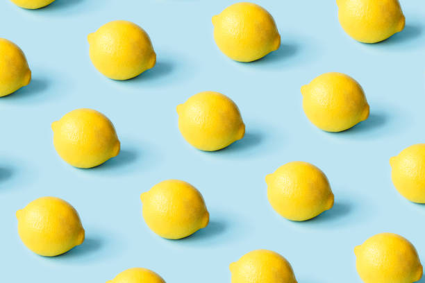 istock Pattern of ripe lemons on a blue background. 1307874787