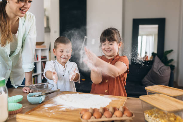 istock mother and kids baking together at home 1307874891