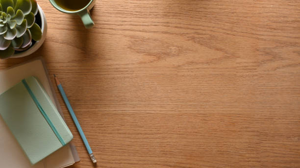 istock Creative flat lay wooden workspace with stationery, plat pot, mug and copy space 1307875178