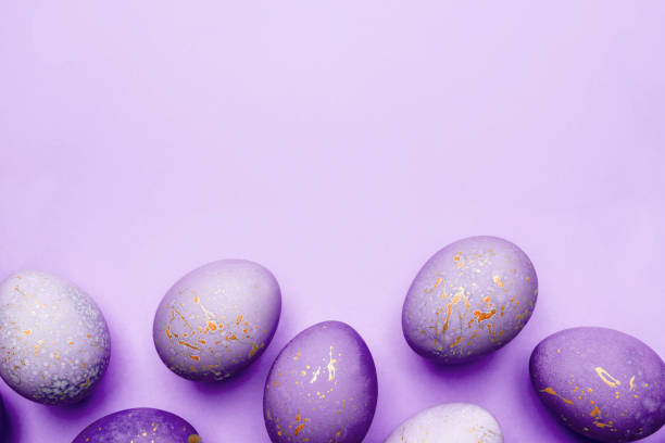 istock Easter frame of eggs painted in purple color. 1307875968