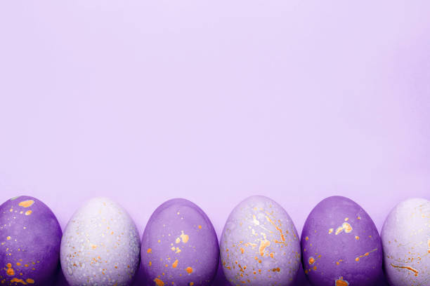 istock Easter frame of eggs painted in purple color. 1307875973