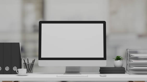 istock 3D rendering, office desk with computer, stationery and office supplies in blurred background 1307875996