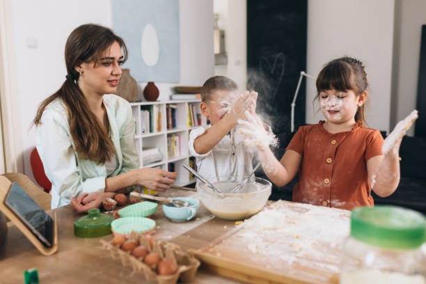 istock mother and kids baking together at home 1307876108