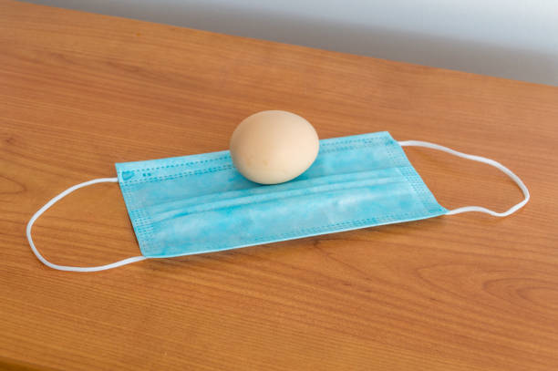 istock Egg on a surgical mask as a symbol of Easter during the coronavirus pandemic. 1307876149