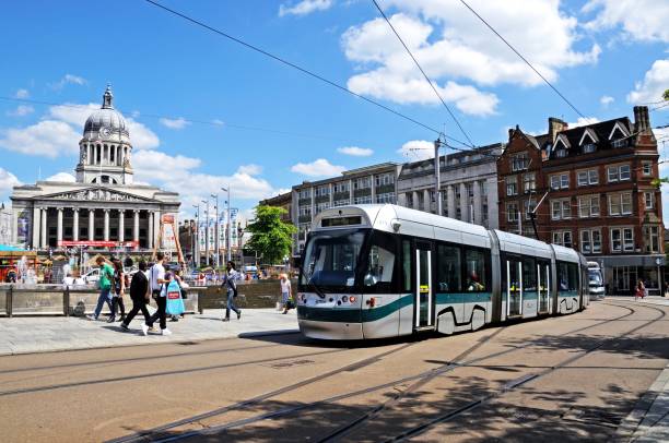 Tram passing the City Hall, Nottingham. Modern tram passing the Council House also known as the city hall in the Old Market Square, Nottingham, Nottinghamshire, England, UK, Western Europe. nottingham stock pictures, royalty-free photos & images