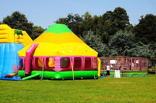 Bouncy castle and enclosed play area in the park, Tamworth, Staffordshire, England, UK, Western Europe.