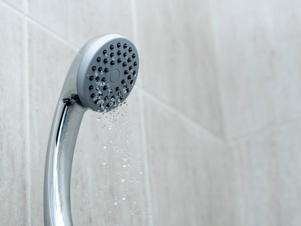 istock Shower head with low water stream. Broken shower in the bathroom 1307878493