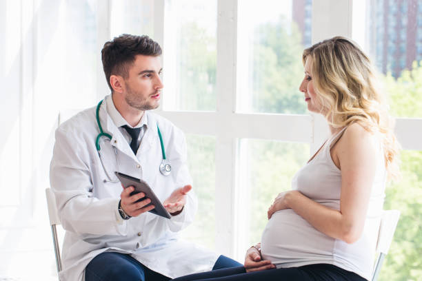 istock Pregnant woman visiting doctor 1307879651