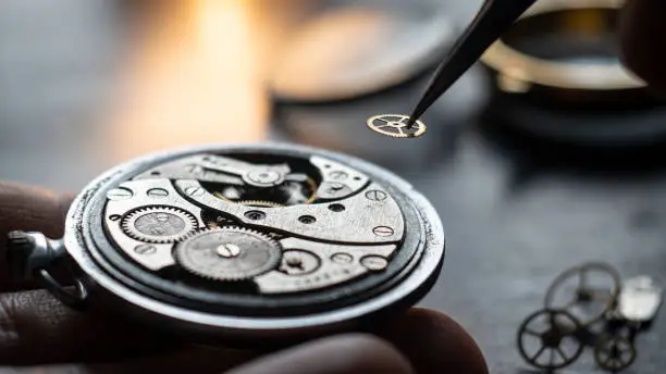 Mechanical watch repair process. Open pocket wristwatch. Doing precise job. Craftsman. Watchmaker adjust watch. Precise occupation. High accuray level