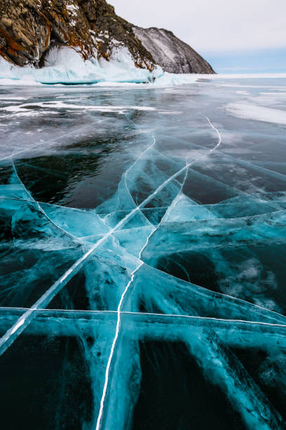 istock Transparent blue ice on Baikal lake in winter 1307882118