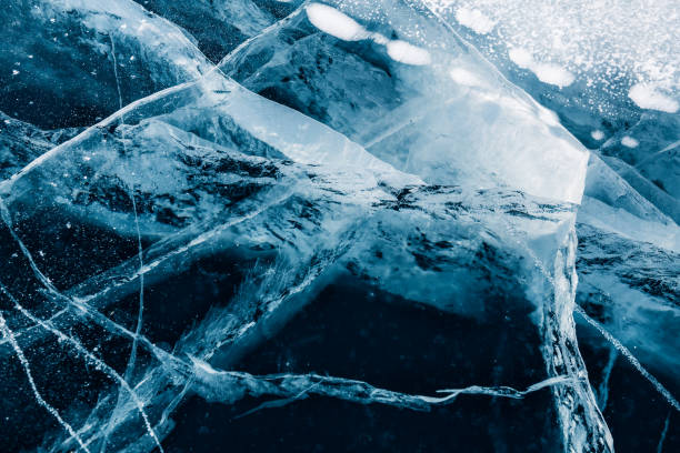 istock Transparent cracked blue ice on Baikal lake in winter. 1307882129