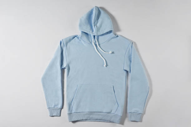istock Blue jacket with a hood lies on a light background 1307883301