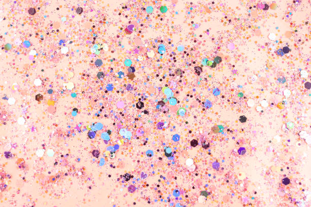 istock Shiny glitter on light pink background, top view 1307883775