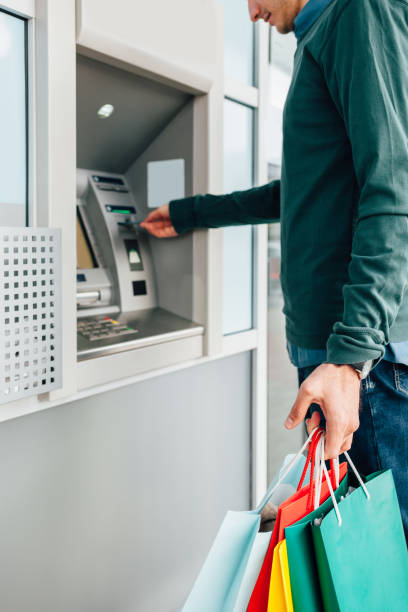 istock Man Withdrawing Money From ATM 1307884461
