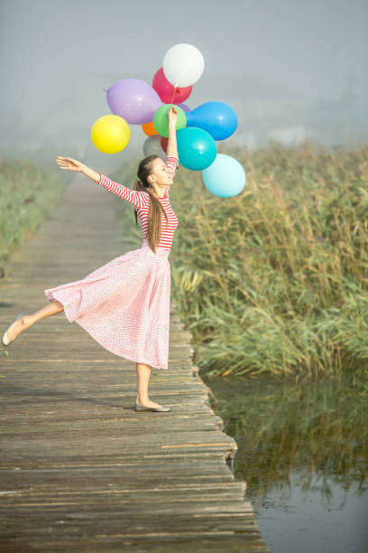 Young woman with balloons  early in the morning