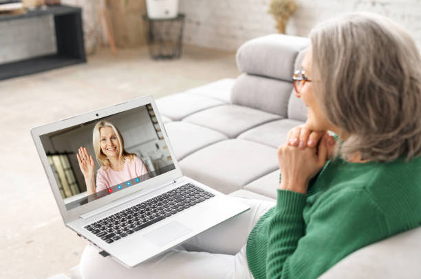 istock Mature senior woman using a laptop at home 1307887789