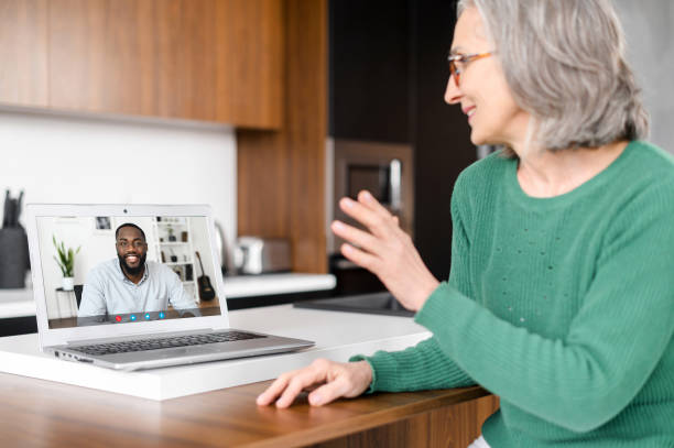 istock Mature senior woman using a laptop for video call 1307887986