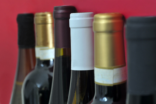 Bottles of wine in close-up on a red background