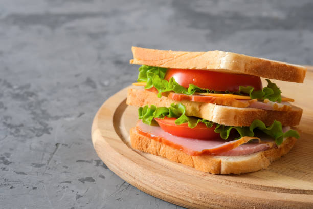 istock Big tasty sandwich on gray background 1307889442