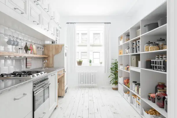 Photo of Modern Kitchen Interior With White Cabinets And Organised Pantry Items, Nonperishable Food Staples, Preserved Foods, Healthy Eating, Fruits And Vegetables In Storage Compartment.