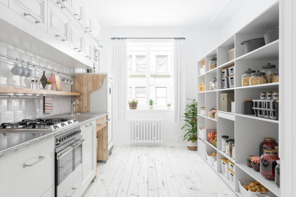 modern kitchen interior with white cabinets and organised pantry items, nonperishable food staples, preserved foods, healthy eating, fruits and vegetables in storage compartment. - cooking process imagens e fotografias de stock