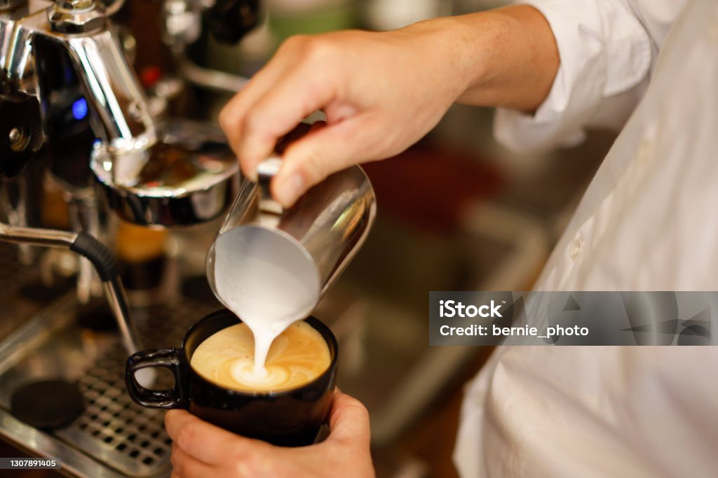 Barista hand making cappuccino Coffee Barista hand making cappuccino Coffee with espresso machine in cafe Cafe Stock Photo