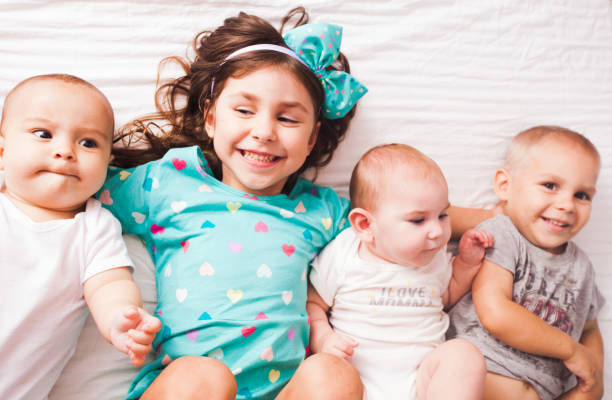 istock Cute Kids Lying On Bed At Home 1307893012