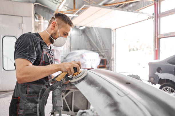 The mechanic works with a grinding tool. Sanding of car elements. Garage painting car service. Repairing car section after the accident. The mechanic works with a grinding tool. Sanding of car elements. Garage painting car service. Repairing car section after the accident sand paper stock pictures, royalty-free photos & images