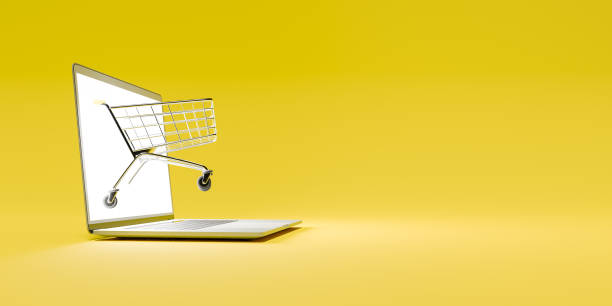 istock shopping cart coming out of a computer screen 1307894294