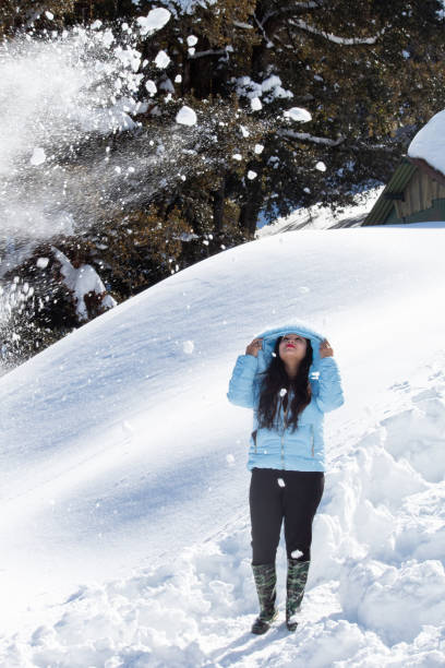istock Woman having fun on snowcapped mountain 1307894579
