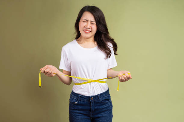 istock Woman holding measuring tape 1307895297