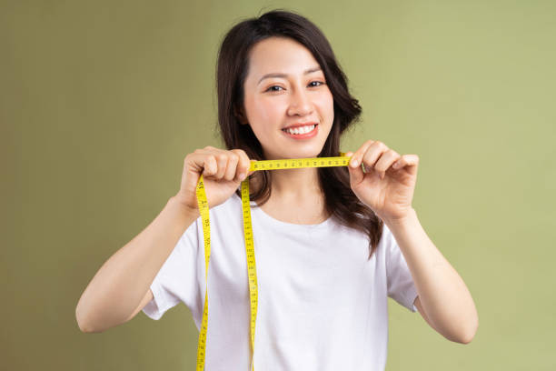 istock Woman holding measuring tape 1307895327