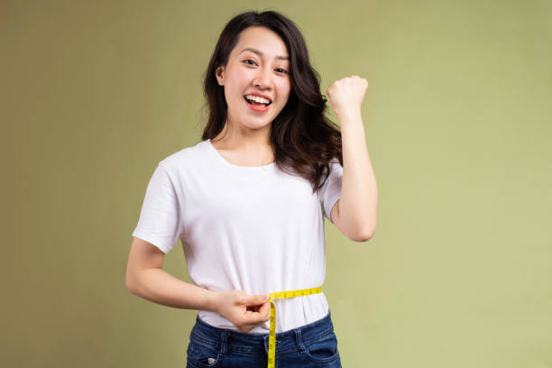 istock Woman holding measuring tape 1307895876