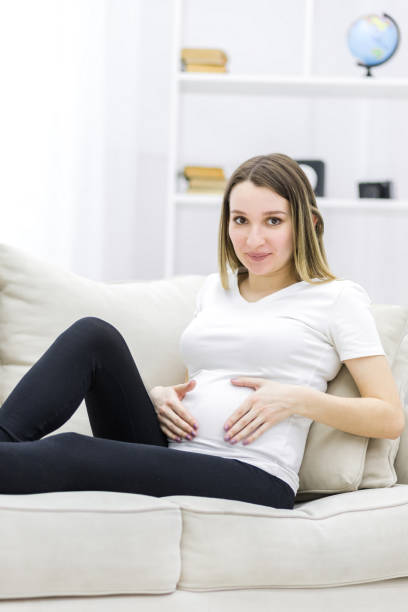 istock Young pregnant woman looking at the camera. 1307897657