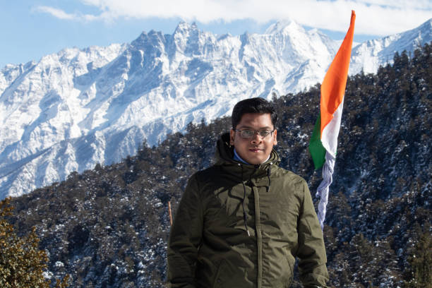 istock Man with Indian flag on Himalayas 1307898811