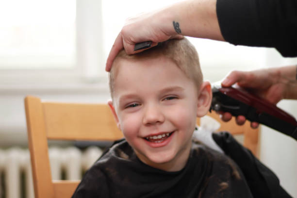 istock Smiling Little boy Getting Haircut At Home 1307899065