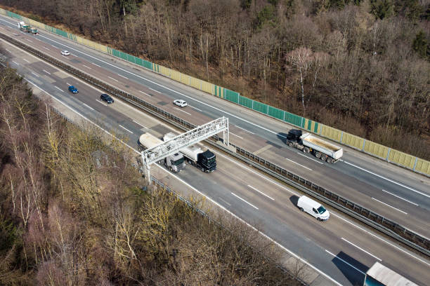 istock Truck toll system on highway - control gantry, aerial view 1307899077
