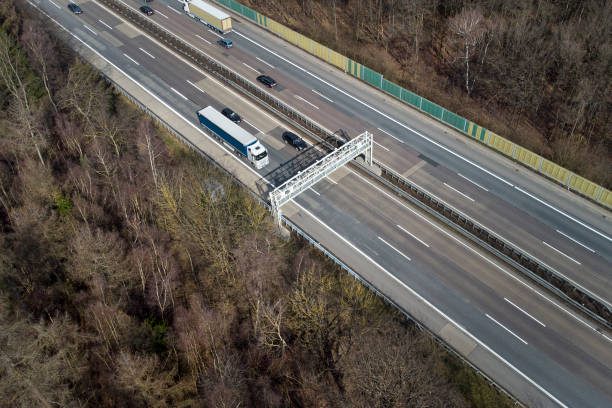 istock Truck toll system on highway - control gantry, aerial view 1307899102