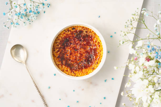 creme brulee. traditional french vanilla cream dessert.spanish crema catalana with flowers - custard creme brulee french cuisine crema catalana imagens e fotografias de stock