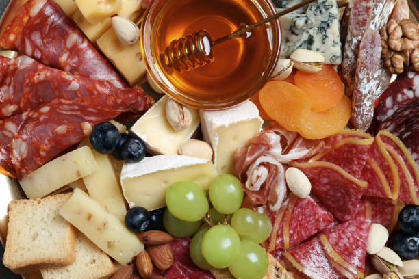 istock Different appetizers with delicious honey as background, top view 1307901597