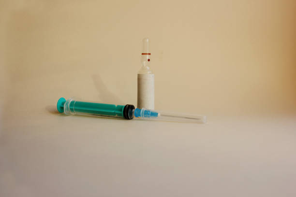 istock A syringe with a needle, amulets with medicine on a blue background. Vaccination. Coronavirus. The concept of medicine and immunity. Vaccination against viral infections. Flatly. Copy space 1307901638