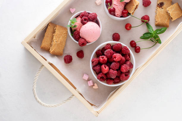istock Ice cream, fresh berries, cookies in a tray close-up. 1307902036