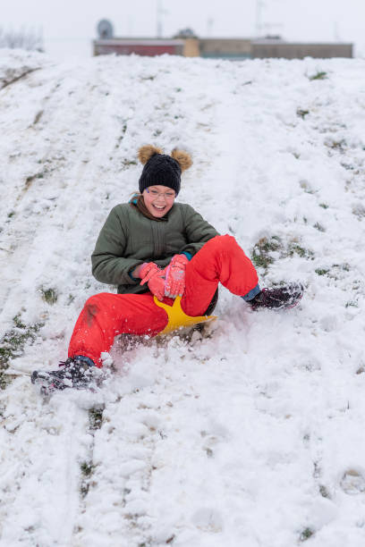 istock Girl On A Plastic Sled Playing on The Snow 1307902862
