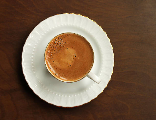 Frothy coffee on wooden background, to