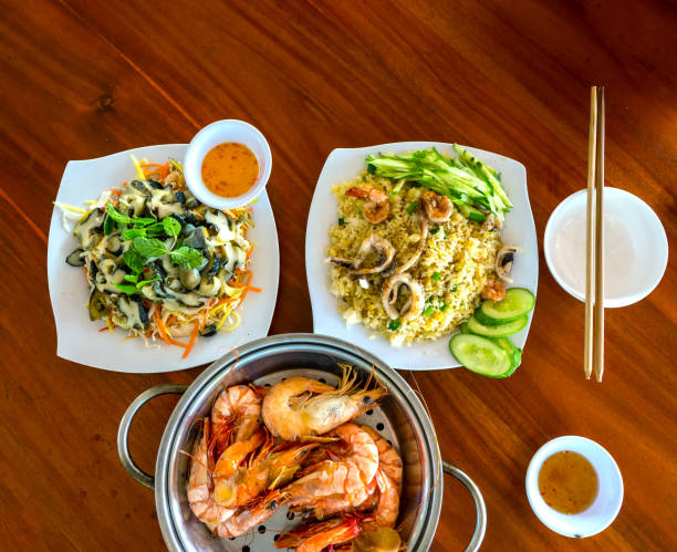 istock Seafood dishes on the table include fried rice, snail salad, steamed shrimp 1307905112