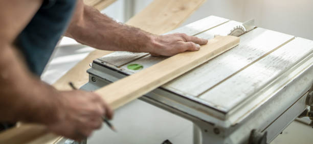 istock Carpenter at the table circular saw 1307906775